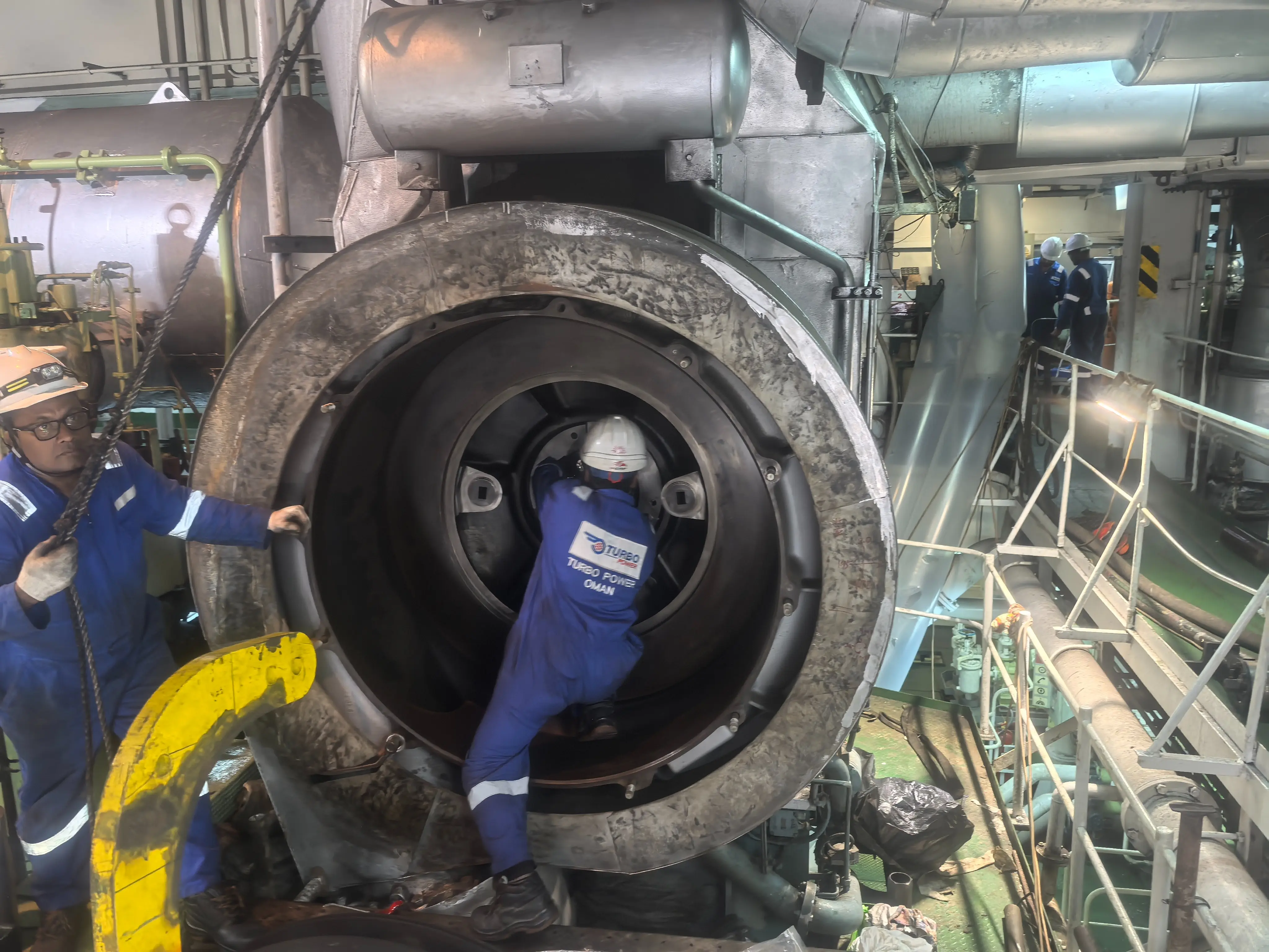 Technician performing onboard turbocharger repair aboard a marine vessel at UAE port
